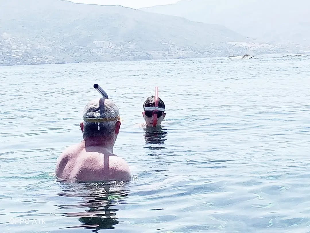 Rubes Levada and a young athlete with centre snorkels during an open water session in the sea at Béjaïa