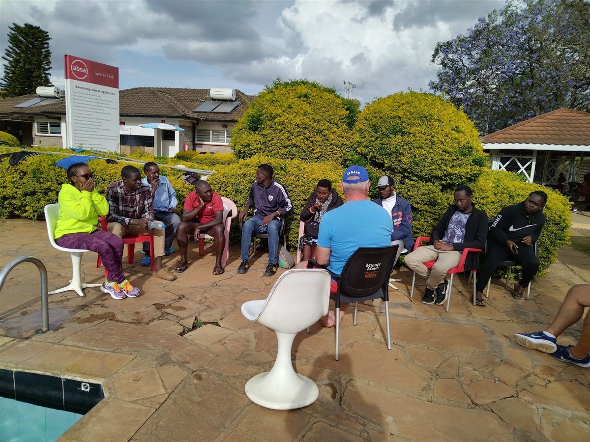 Poolside briefing with coaches and athletes
