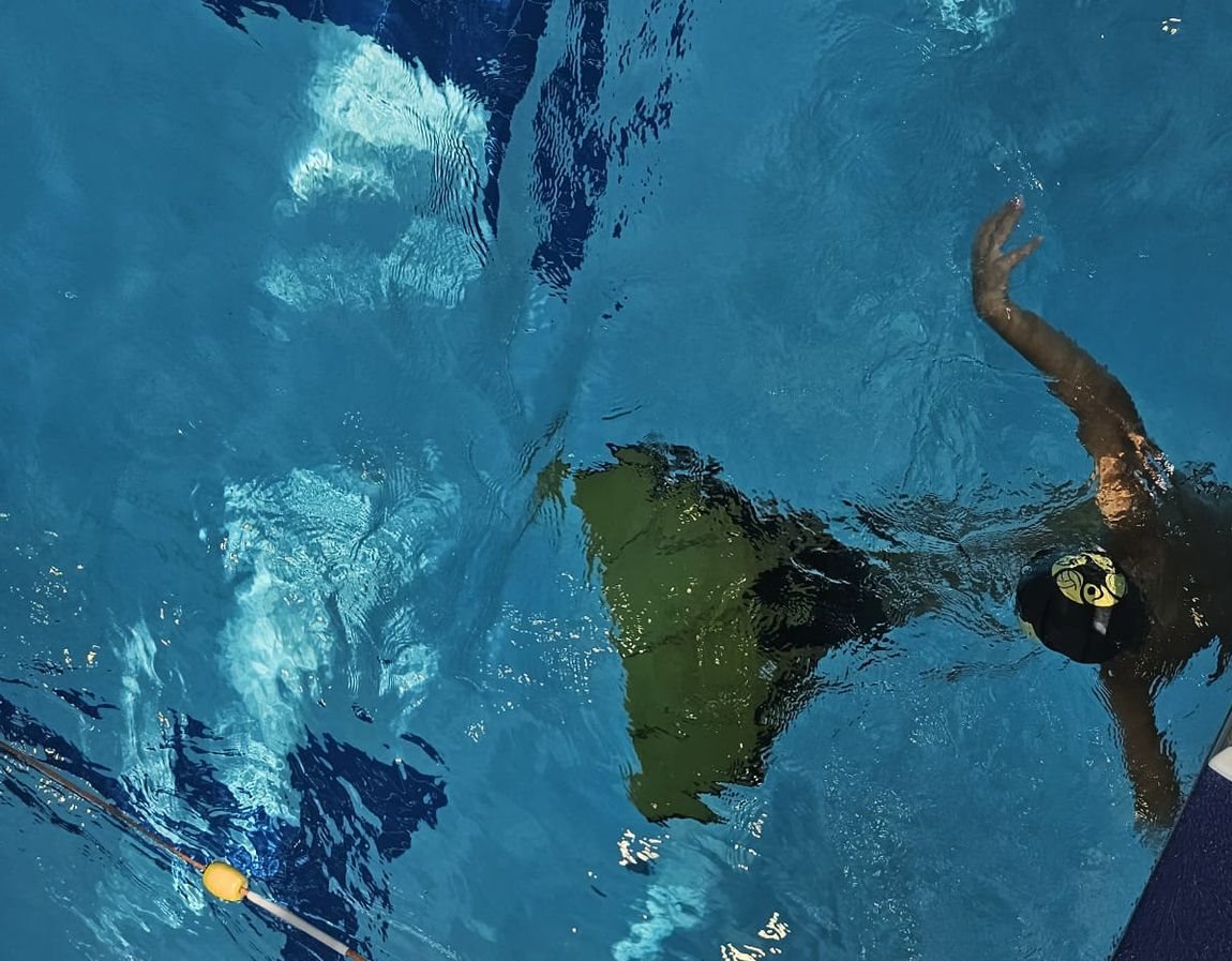 Young finswimmer with a monofin in the pool
